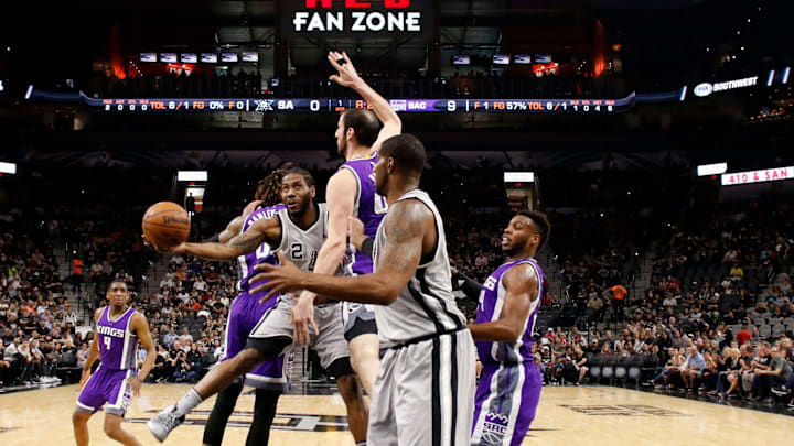 Mar 19, 2017; San Antonio, TX, USA; San Antonio Spurs small forward Kawhi Leonard (2) passes the ball around Sacramento Kings center Kosta Koufos (41) to LaMarcus Aldridge (12) during the first half at AT&T Center. Mandatory Credit: Soobum Im-USA TODAY Sports