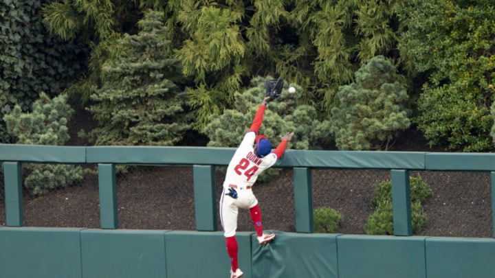 Apr 17, 2021; Philadelphia, Pennsylvania, USA; Philadelphia Phillies center fielder Roman Quinn (24) leaps in attempt to catch a home run hit by St. Louis Cardinals shortstop Pual DeJong (11) (not pictured) during the third inning at Citizens Bank Park. Mandatory Credit: Gregory Fisher-USA TODAY Sports