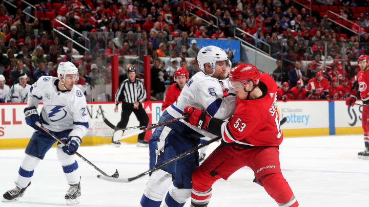 RALEIGH, NC – APRIL 7: Jeff Skinner #53 of the Carolina Hurricanes is separated from the puck on a defensive play by Anton Stralman #6 of the Tampa Bay Lightning during an NHL game on April 7, 2018 at PNC Arena in Raleigh, North Carolina. (Photo by Gregg Forwerck/NHLI via Getty Images)