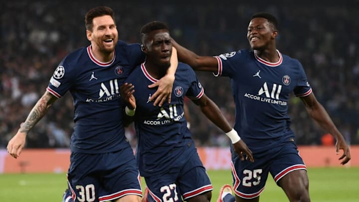 TOPSHOT - Paris Saint-Germain's Senegalese midfielder Idrissa Gana Gueye (C) celebrates with Paris Saint-Germain's Argentinian forward Lionel Messi (L) and Paris Saint-Germain's Portuguese defender Nuno Mendes after scoring a goal during the UEFA Champions League first round group A football match between Paris Saint-Germain's (PSG) and Manchester City, at The Parc des Princes, in Paris, on September 28, 2021. (Photo by FRANCK FIFE / AFP) (Photo by FRANCK FIFE/AFP via Getty Images)
