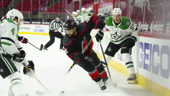 Jan 30, 2021; Raleigh, North Carolina, USA; Carolina Hurricanes center Vincent Trocheck (16) battles for the puck against Dallas Stars center Tanner Kero (64) during the third period at PNC Arena. Mandatory Credit: James Guillory-USA TODAY Sports