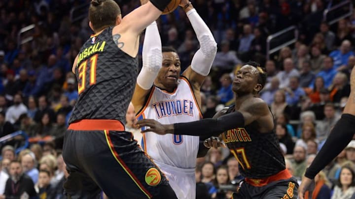 Dec 19, 2016; Oklahoma City, OK, USA; Oklahoma City Thunder guard Russell Westbrook (0) drives to the basket between Atlanta Hawks forward Mike Muscala (31) and Atlanta Hawks guard Dennis Schroder (17) during the second quarter at Chesapeake Energy Arena. Mandatory Credit: Mark D. Smith-USA TODAY Sports