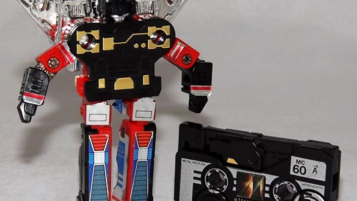 A Transformers action figure and cassette