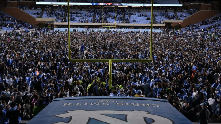 CHAPEL HILL, NORTH CAROLINA - NOVEMBER 11: North Carolina Tar Heels fans storm the field after a win against the Duke Blue Devils at Kenan Memorial Stadium on November 11, 2023 in Chapel Hill, North Carolina. The Tar Heels won 47-45 in double overtime. (Photo by Grant Halverson/Getty Images)