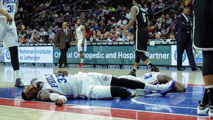 Mar 11, 2016; Philadelphia, PA, USA; Philadelphia 76ers forward Robert Covington (33) and 76ers forward Jerami Grant (39) after colliding during the third quarter of the game against the Brooklyn Nets at the Wells Fargo Center. Mandatory Credit: John Geliebter-USA TODAY Sports