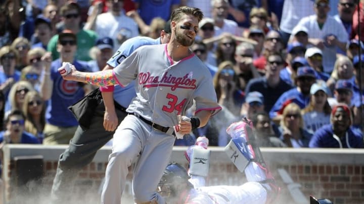 May 8, 2016; Chicago, IL, USA; Washington Nationals right fielder Bryce Harper (34) scores a run as Chicago Cubs catcher Tim Federowicz (15) makes a late tag during the third inning at Wrigley Field. Mandatory Credit: David Banks-USA TODAY Sports