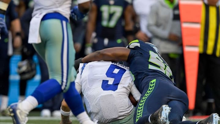Aug 25, 2016; Seattle, WA, USA; Dallas Cowboys quarterback Tony Romo (9) is tackled by Seattle Seahawks defensive end Cliff Avril (56) during the first half of an NFL football game at CenturyLink Field. Mandatory Credit: Kirby Lee-USA TODAY Sports