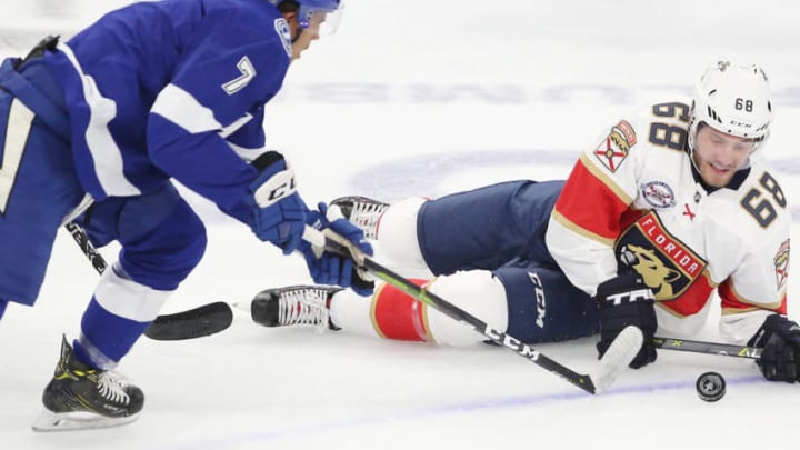 The Tampa Bay Lightning's Mathieu Joseph (7) takes the puck from falling Florida Panthers player Mike Hoffman (68) in an exhibition game at the Amway Center in Orlando, Fla., on Thursday, Sept. 27, 2018. (Stephen M. Dowell/Orlando Sentinel/TNS via Getty Images)