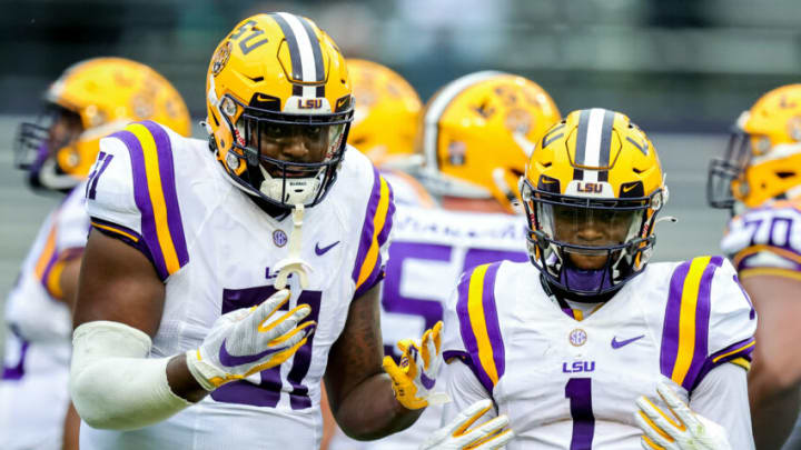 Apr 17, 2021; Baton Rouge, Louisiana, USA; LSU Tigers offensive tackle Dare Rosenthal (51) and LSU Tigers wide receiver Kayshon Boutte (1) pose for the camera on a time out during the first half of the annual Purple and White spring game at Tiger Stadium. Mandatory Credit: Stephen Lew-USA TODAY Sports