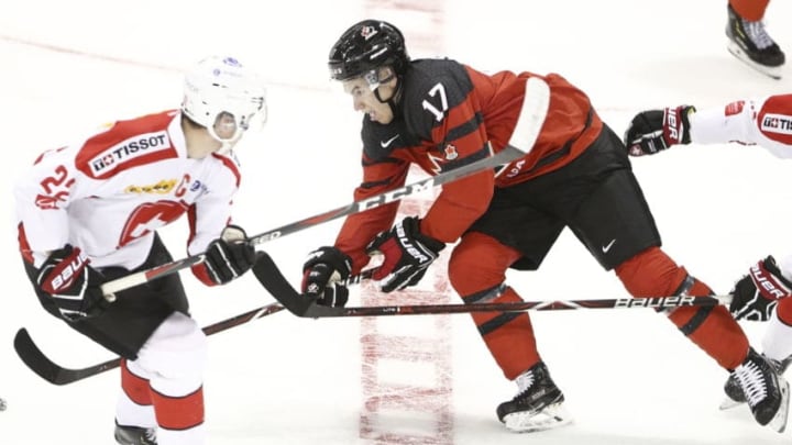 VICTORIA , BC - DECEMBER 19: Nick Suzuki #17 of Team Canada skates with the puck while being checked by Nando Eggenberger #22 and chased by Gianluca Burger #7 of Team Switzerland at the IIHF World Junior Championships at the Save-on-Foods Memorial Centre on December 19, 2018 in Victoria, British Columbia, Canada. Canada defeated Switzerland 5-3. (Photo by Kevin Light/Getty Images)"n"n"n"n