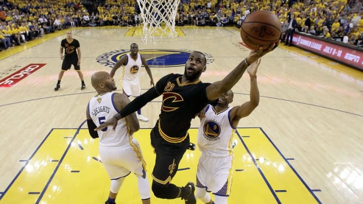 Jun 19, 2016; Oakland, CA, USA; Cleveland Cavaliers forward LeBron James (23) shoots the ball against Golden State Warriors center Marreese Speights (5) and forward Andre Iguodala (9) in game seven of the NBA Finals at Oracle Arena. Mandatory Credit: Marcio Jose Sanchez-Pool Photo via USA TODAY Sports