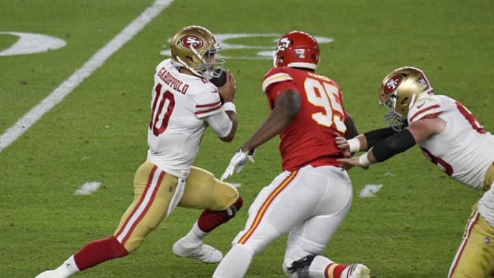 MIAMI, FLORIDA - FEBRUARY 02: Jimmy Garoppolo #10 of the San Francisco 49ers looks to avoid the pressure from Chris Jones #95 of the Kansas City Chiefs in Super Bowl LIV at Hard Rock Stadium on February 02, 2020 in Miami, Florida. The Chiefs won the game 31-20. (Photo by Focus on Sport/Getty Images)