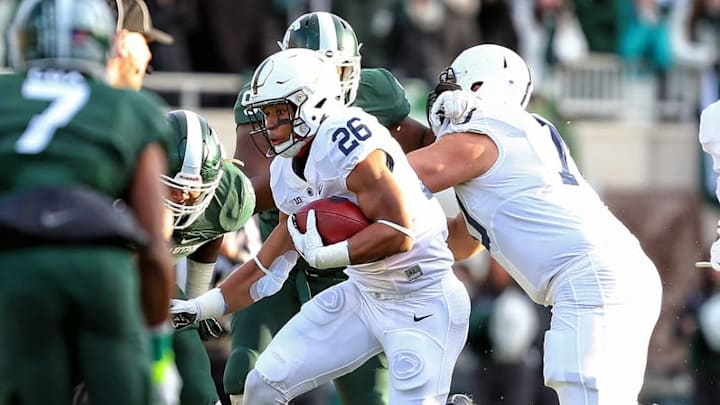 Nov 28, 2015; East Lansing, MI, USA; Penn State Nittany Lions running back Saquon Barkley (26) runs the ball during the first quarter of a game against the Michigan State Spartans at Spartan Stadium. Mandatory Credit: Mike Carter-USA TODAY Sports