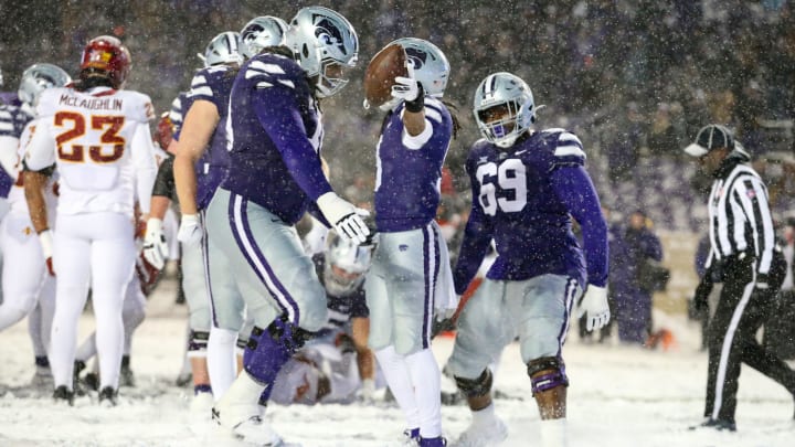 Nov 25, 2023; Manhattan, Kansas, USA; Kansas State Wildcats running back Treshaun Ward (9), offensive lineman KT Leveston (70) and offensive lineman Taylor Poitier (69) celebrate a touchdown in the fourth quarter against the Iowa State Cyclones at Bill Snyder Family Football Stadium. Mandatory Credit: Scott Sewell-USA TODAY Sports