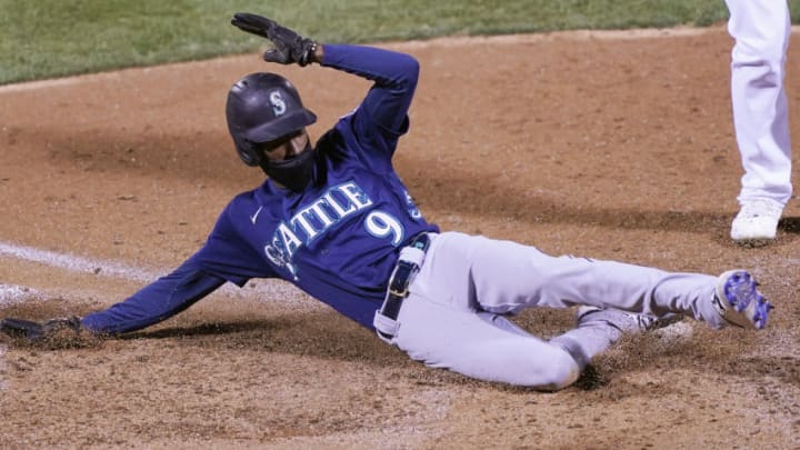 OAKLAND, CALIFORNIA - SEPTEMBER 25: Dee Strange-Gordon #9 of the Seattle Mariners scores on a passed ball against the Oakland Athletics in the top of the 10th inning at RingCentral Coliseum on September 25, 2020 in Oakland, California. (Photo by Thearon W. Henderson/Getty Images)