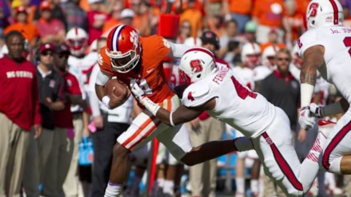 Oct 4, 2014; Clemson, SC, USA; Clemson Tigers quarterback Deshaun Watson (4) carries the ball as North Carolina State Wolfpack linebacker Jerod Fernandez (4) defends during the first quarter at Clemson Memorial Stadium. Mandatory Credit: Joshua S. Kelly-USA TODAY Sports