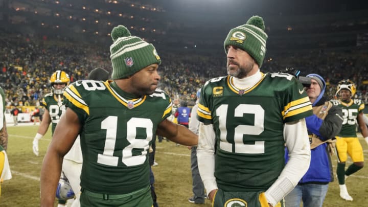 GREEN BAY, WISCONSIN - JANUARY 08: Aaron Rodgers #12 and Randall Cobb #18 of the Green Bay Packers walk off the field after losing to the Detroit Lions at Lambeau Field on January 08, 2023 in Green Bay, Wisconsin. Jets (Photo by Patrick McDermott/Getty Images)
