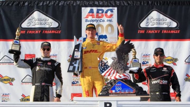 Aug 23, 2015; Long Pond, PA, USA; Verizon IndyCar Series driver Ryan Hunter-Reay (center) holds the winners trophy as driver Josef Newgarden (left) holds the second place trophy and driver Juan Pablo Montoya (right) holds the third place trophy following the competition of the ABC Supply 500 at Pocono Raceway. Mandatory Credit: Matthew O