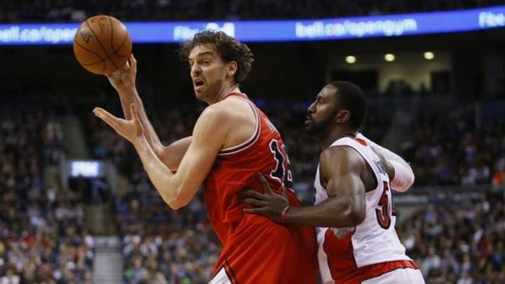 Mar 25, 2015; Toronto, Ontario, CAN; Chicago Bulls forward Pau Gasol (16) passes the ball as Toronto Raptors forward Patrick Patterson (54) defends at the Air Canada Centre. Chicago defeated Toronto 116-103. Mandatory Credit: John E. Sokolowski-USA TODAY Sports