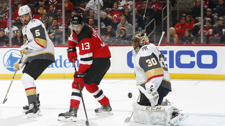 NEWARK, NJ – DECEMBER 3: Malcolm Subban #30 of the Vegas Golden Knights makes a save against Nico Hischier #13 of the New Jersey Devils the game at the Prudential Center on December 3, 2019 in Newark, New Jersey. (Photo by Andy Marlin/NHLI via Getty Images)