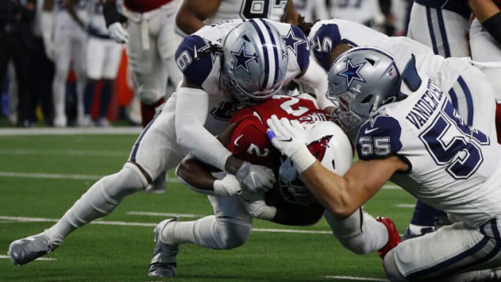 ARLINGTON, TEXAS - JANUARY 02: Chase Edmonds #2 of the Arizona Cardinals runs the ball and is tackled by Donovan Wilson #6 and Leighton Vander Esch #55 of the Dallas Cowboys during the first quarter at AT&T Stadium on January 02, 2022 in Arlington, Texas. (Photo by Richard Rodriguez/Getty Images)