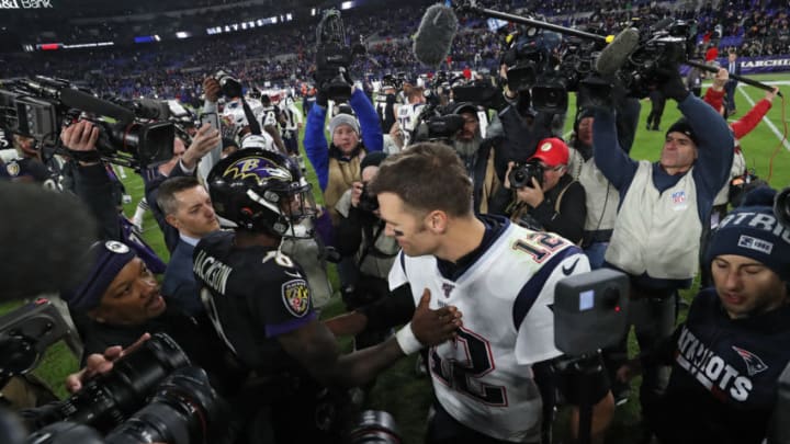 BALTIMORE, MARYLAND - NOVEMBER 03: Quarterback Lamar Jackson #8 of the Baltimore Ravens and quarterback Tom Brady #12 of the New England Patriots talk after the Ravens defeated the Patriots at M&T Bank Stadium on November 3, 2019 in Baltimore, Maryland. (Photo by Todd Olszewski/Getty Images)