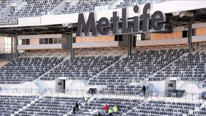 Jan 22, 2014; East Rutherford, NJ, USA; A general view as stadium workers clean snow from stands during the Super Bowl XLVIII stadium preparations press conference at MetLife Stadium. Mandatory Credit: Joe Camporeale-USA TODAY Sports