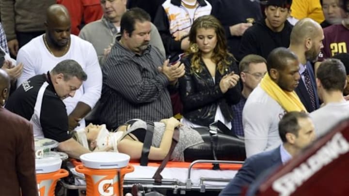 Dec 17, 2015; Cleveland, OH, USA; Ellie Day, wife of golfer Jason Day (not pictured), leaves the arena on a stretcher after she was run into by Cleveland Cavaliers forward LeBron James (not pictured) while she sat in the front row during a game between the Cleveland Cavaliers and the Oklahoma City Thunder at Quicken Loans Arena. Mandatory Credit: David Richard-USA TODAY Sports