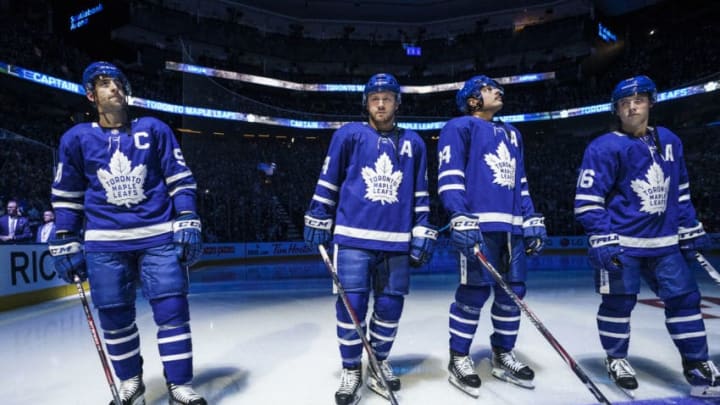 TORONTO, ON - OCTOBER 2: Toronto Maple Leafs new captain John Tavares #91 stands alongside alternate captains Morgan Rielly #44, Auston Matthews #34 and Mitch Marner #16 before facing the Ottawa Senators in the season opener at the Scotiabank Arena on October 2, 2019 in Toronto, Ontario, Canada. (Photo by Mark Blinch/NHLI via Getty Images)