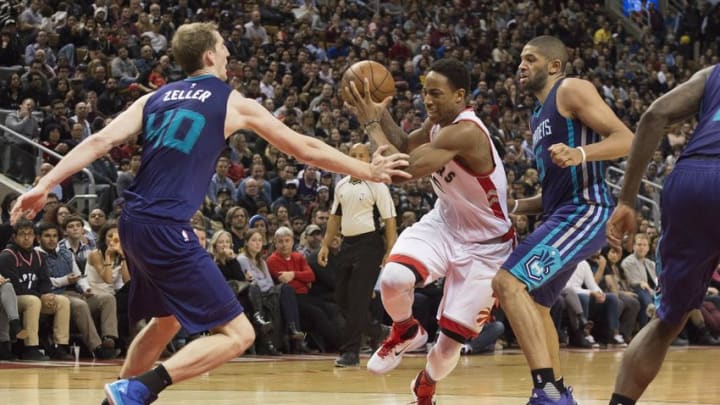 Jan 1, 2016; Toronto, Ontario, CAN; Toronto Raptors guard DeMar DeRozan (10) drives to the basket as Charlotte Hornets center Cody Zeller (40) and guard Nicolas Batum (5) try to defend during the fourth quarter in a game at Air Canada Centre. The Toronto Raptors won 104-94. Mandatory Credit: Nick Turchiaro-USA TODAY Sports