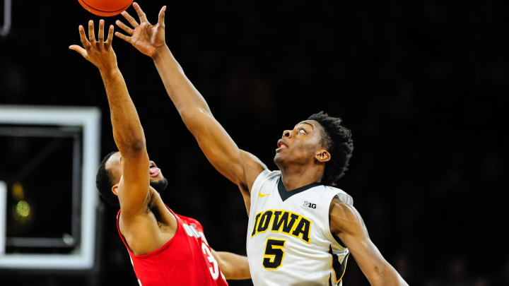 Jan 28, 2017; Iowa City, IA, USA; Iowa Hawkeyes forward Tyler Cook (5) and Ohio State Buckeyes center Trevor Thompson (32) battle for the opening tipoff during the first half at Carver-Hawkeye Arena. Mandatory Credit: Jeffrey Becker-USA TODAY Sports