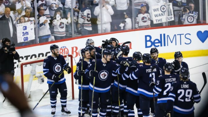WINNIPEG, MB April 20: Winnipeg Jets players celebrate their victory during the Stanley Cup Playoffs First Round Game 5 between the Winnipeg Jets and the Minnesota Wild on April 20, 2018 at the Bell MTS Place in Winnipeg MB. (Photo by Terrence Lee/Icon Sportswire via Getty Images)