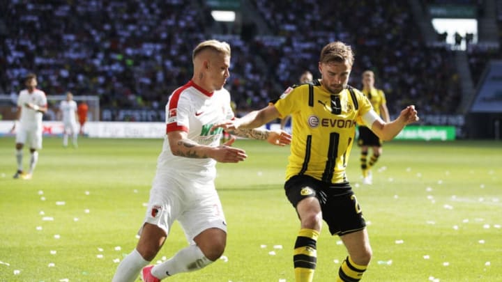 AUGSBURG, GERMANY – MAY 13: Jonathan Schmid of Augsburg challenges Marcel Schmelzer of Borussia Dortmund during the Bundesliga match between FC Augsburg and Borussia Dortmund at WWK Arena on May 13, 2017 in Augsburg, Germany. (Photo by Adam Pretty/Bongarts/Getty Images)