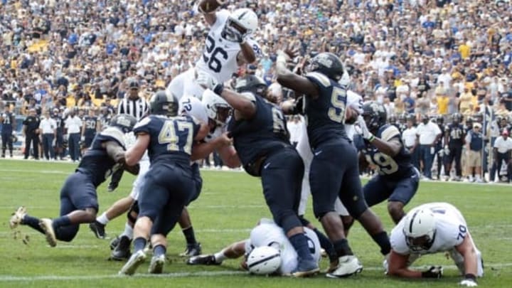 Sep 10, 2016; Pittsburgh, PA, USA; Penn State Nittany Lions running back Saquon Barkley (26) dives over the line of scrimmage into the end-zone for a touchdown against the Pittsburgh Panthers during the second quarter at Heinz Field. Mandatory Credit: Charles LeClaire-USA TODAY Sports