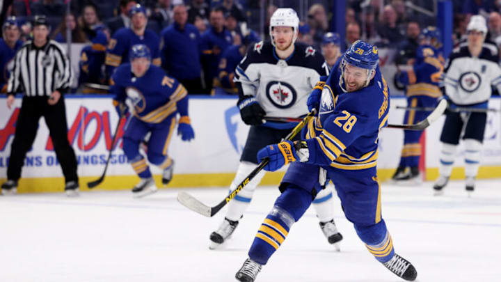 Mar 30, 2022; Buffalo, New York, USA; Buffalo Sabres left wing Zemgus Girgensons (28) takes a shot on goal during the second period against the Winnipeg Jets at KeyBank Center. Mandatory Credit: Timothy T. Ludwig-USA TODAY Sports