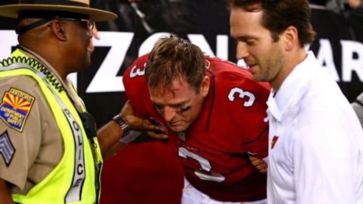 Sep 8, 2014; Glendale, AZ, USA; Arizona Cardinals quarterback Carson Palmer (3) is helped to his feet after losing his balance and falling following the game against the San Diego Chargers at University of Phoenix Stadium. The Cardinals defeated the Chargers 18-17. Mandatory Credit: Mark J. Rebilas-USA TODAY Sports