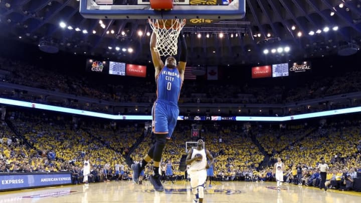 May 16, 2016; Oakland, CA, USA; Oklahoma City Thunder guard Russell Westbrook (0) dunks the basketball against the Golden State Warriors during the third quarter in game one of the Western conference finals of the NBA Playoffs at Oracle Arena. The Thunder defeated the Warriors 108-102. Mandatory Credit: Thearon W. Henderson-Pool Photo via USA TODAY Sports