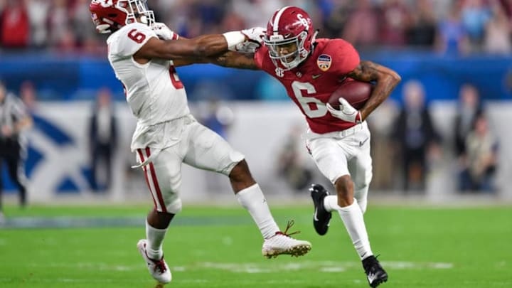 MIAMI GARDENS, FL - DECEMBER 29: Alabama wide receiver Devonta Smith (6) stiff-arms Oklahoma cornerback cornerback Tre Brown (6) during the first half of the CFP Semifinal at the Orange Bowl between Alabama Crimson Tide and the Oklahoma Sooners on December 29, 2018, at Hard Rock Stadium in Miami Gardens, FL. (Photo by Roy K. Miller/Icon Sportswire via Getty Images)