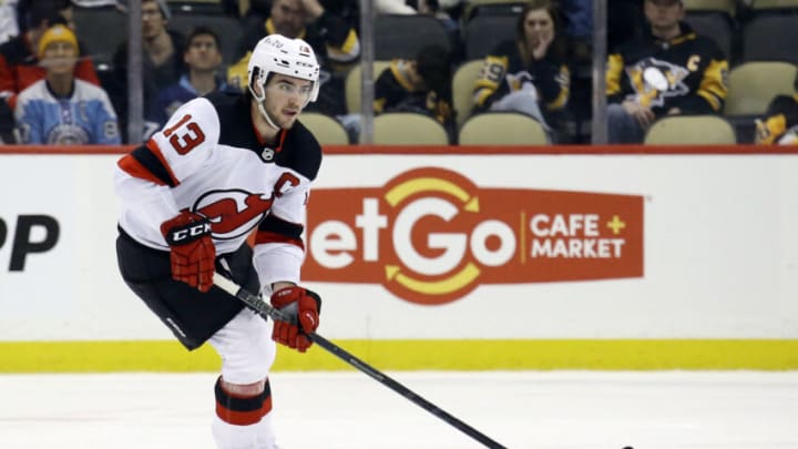 Feb 24, 2022; Pittsburgh, Pennsylvania, USA; New Jersey Devils center Nico Hischier (13) skates with he puck against the Pittsburgh Penguins during the third period at PPG Paints Arena. The Devils won 6-1. Mandatory Credit: Charles LeClaire-USA TODAY Sports