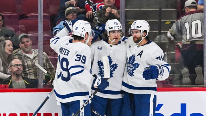 Sep 30, 2023; Montreal, Quebec, CAN; Toronto Maple Leafs left wing Matthew Knies (23) celebrates his goal against the Montreal Canadiens with center Fraser Minten (39) and defenseman TJ Brodie (78) during the first period at Bell Centre. Mandatory Credit: David Kirouac-USA TODAY Sports