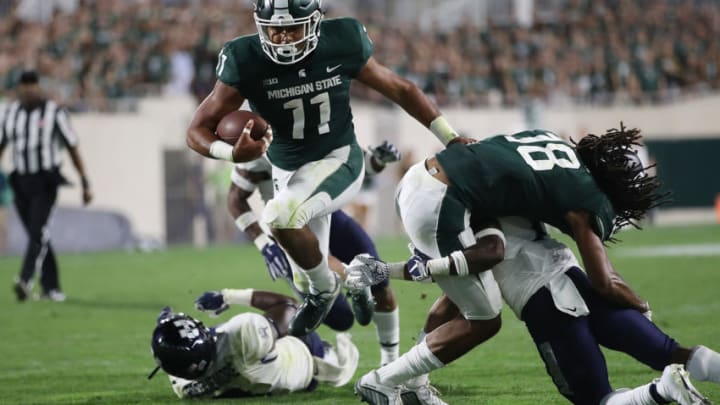 EAST LANSING, MI - AUGUST 31: Connor Heyward #11 of the Michigan State Spartans scores a third quarter touchdown while playing the Utah State Aggies at Spartan Stadium on August 31, 2018 in East Lansing, Michigan. Michigan State won the game 38-31. (Photo by Gregory Shamus/Getty Images)