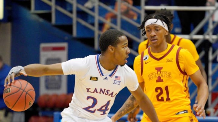 Feb 11, 2021; Lawrence, Kansas, USA; Kansas Jayhawks guard Bryce Thompson (24) dribbles the ball as Iowa State Cyclones guard Jaden Walker (21) defends during the game at Allen Fieldhouse. Mandatory Credit: Denny Medley-USA TODAY Sports