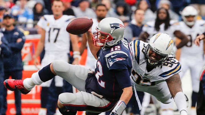 FOXBORO, MA - OCTOBER 29: Tom Brady #12 of the New England Patriots is tackled by Darius Philon #93 of the Los Angeles Chargers during the fourth quarter of a game at Gillette Stadium on October 29, 2017 in Foxboro, Massachusetts. (Photo by Jim Rogash/Getty Images)