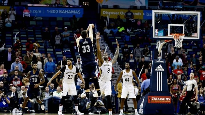 Dec 5, 2016; New Orleans, LA, USA; Memphis Grizzlies center Marc Gasol (33) shoots a three pointer over New Orleans Pelicans forward Terrence Jones (9) in the final seconds of the fourth quarter of a game at the Smoothie King Center. The Grizzlies defeated the Pelicans 110-108 in double overtime. Mandatory Credit: Derick E. Hingle-USA TODAY Sports