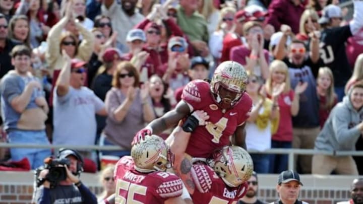 Nov 14, 2015; Tallahassee, FL, USA; Florida State Seminoles running back Dalvin Cook (4) celebrates a touchdown with offensive lineman Alec Eberle (54) and offensive lineman Chad Mavety (55) during the second half of the game against the North Carolina State Wolfpack at Doak Campbell Stadium. Mandatory Credit: Melina Vastola-USA TODAY Sports