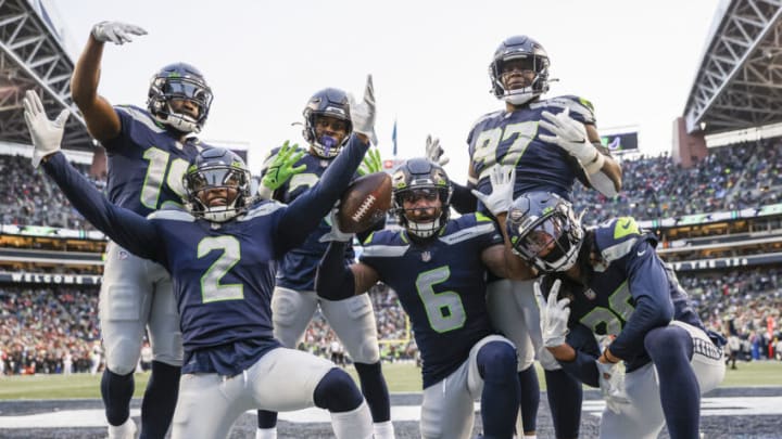 SEATTLE, WASHINGTON - DECEMBER 05: Quandre Diggs #6 of the Seattle Seahawks celebrates an interception with teammates during the third quarter against the San Francisco 49ers at Lumen Field on December 05, 2021 in Seattle, Washington. The interception was later ruled by officials as an incomplete pass. (Photo by Steph Chambers/Getty Images)