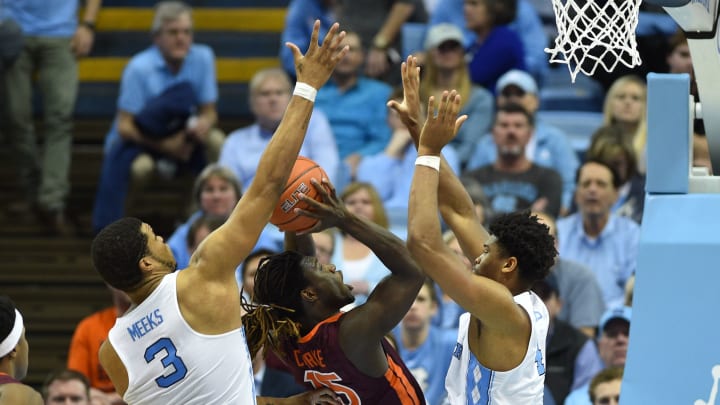 Jan 26, 2017; Chapel Hill, NC, USA; Virginia Tech Hokies guard Chris Clarke (15) with the ball as North Carolina Tar Heels forwards Kennedy Meeks (3) and Isaiah Hicks (4) defends in the second half. The Tar Heels defeated the Hokies 91-72 at Dean E. Smith Center. Mandatory Credit: Bob Donnan-USA TODAY Sports