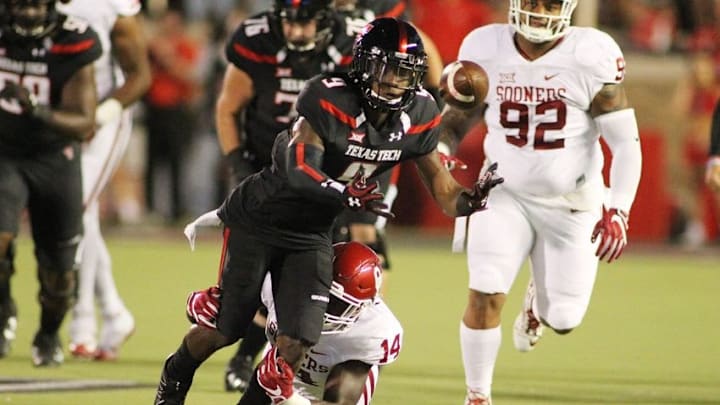 Oct 22, 2016; Lubbock, TX, USA; Texas Tech Red Raiders wide receiver Jonathan Giles (9) loses the ball while being tackled by Oklahoma Sooners defensive end Emmanuel Beal (14) in the first half at Jones AT&T Stadium. Mandatory Credit: Michael C. Johnson-USA TODAY Sports