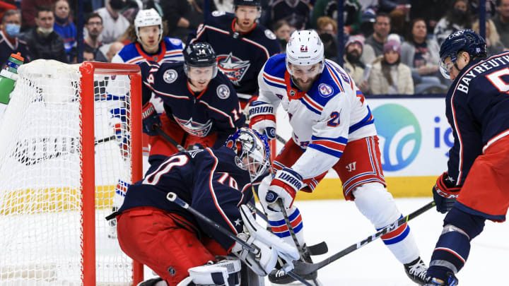 Jan 27, 2022; Columbus, Ohio, USA; Columbus Blue Jackets goaltender Joonas Korpisalo (70) makes a save in net against New York Rangers center Barclay Goodrow (21) in the third period at Nationwide Arena. Mandatory Credit: Aaron Doster-USA TODAY Sports