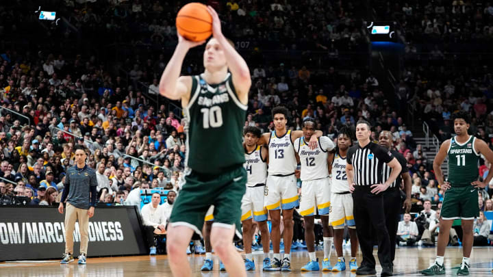 Mar 19, 2023; Columbus, Ohio, USA; Marquette Golden Eagles players watch as Michigan State Spartans forward Joey Hauser (10) shoots free throws during the second round of the NCAA men’s basketball tournament at Nationwide Arena. Mandatory Credit: Adam Cairns-The Columbus DispatchBasketball Ncaa Men S Basketball Tournament Round 2